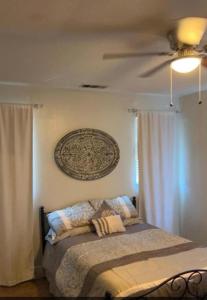 a bedroom with a bed with a ceiling fan at Home Away From Home in Eastvale