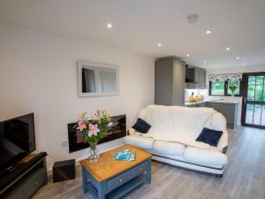 a living room with a white couch and a table at 1 bed in Bude 83632 in Stratton