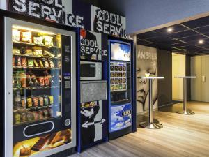 a vending machine with food and drinks in a store at ibis budget Caen Hérouville in Hérouville-Saint-Clair