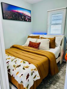 a bedroom with two beds and a tv on the wall at Fancy Studio Private Entrance in Selden