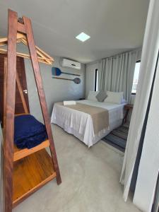 a bedroom with a bunk bed and a ladder at Villas do Rio 02 in Pôrto de Pedras +31 photos
