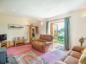a living room with a couch and a chair at 2 Bed in Outgate and Tarn Hows LLH01 in Hawkshead