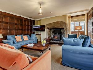 - un salon avec des canapés bleus et une cheminée dans l'établissement 4 Bed in Llanover 91243, à Abergavenny