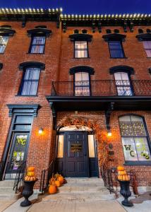 a brick building with pumpkins in front of a door at The Woodford Hotel in Versailles +56 photos