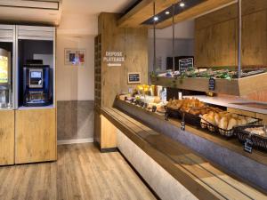 a bakery with bread and other foods on display at Hotel Ibis Budget Montpellier Centre Millenaire - in Montpellier