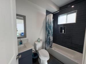 a bathroom with a toilet and a sink and a tub at Blue Hostel Walk to BMO Stadium and USC in Los Angeles +51 photos