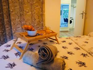 a bed with a table with a towel on it at Habitation Keira in Saint-Denis