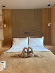 two towel animals are laying on a bed at Inngo Tourist Inn in El Nido +48 photos