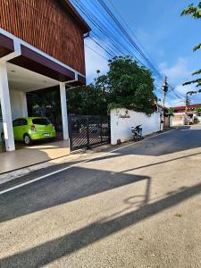 a green car parked in front of a building at บุญเมืองน่าน in Nan