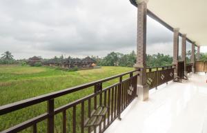 a balcony with a view of a field at Grita Apsari Guest House in Tegalalang