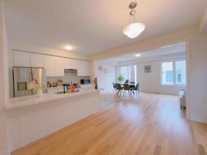 an open living room with a kitchen and a dining room at Vantage stay Modern 4BR townhouse pickering in Pickering +33 photos