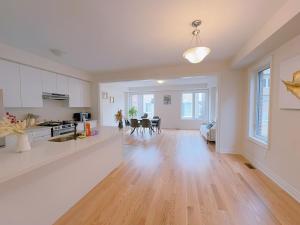 an empty kitchen and living room in a home at Vantage stay Modern 4BR townhouse pickering in Pickering