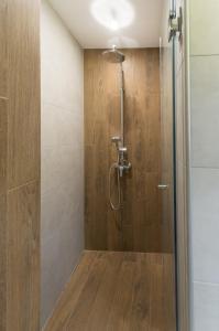 a shower with a glass door in a bathroom at City Apartments La Casa in Varna City