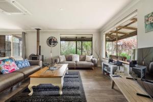 a living room with a couch and a table at Bettenays Margaret River in Metricup