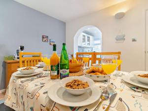 a dining room table with food and bottles and drinks at 3 Bed in Winterton-on-Sea 93210 in Winterton-on-Sea