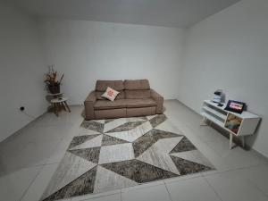 a living room with a couch and a table at Chacaras Leos in Arapiraca
