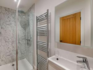 a bathroom with a shower and a sink and a mirror at 3 Bed in Tollerton 93898 in Tollerton +19 photos