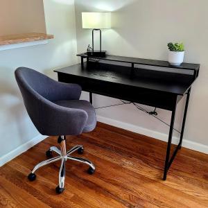 a black desk with a chair and a lamp at Spacious Apt in Fairview NJ Easy Commute to NYC with parking in Fairview