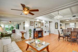 a living room with a couch and a table at 3 Mi to Beach and Boardwalk Riverfront Daytona Home in Holly Hill