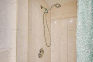 a shower with a shower head in a bathroom at 3 Mi to Beach and Boardwalk Riverfront Daytona Home in Holly Hill +17 photos