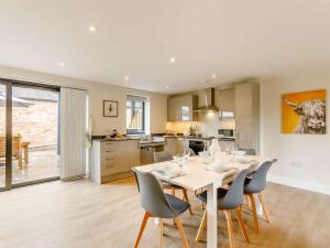 a kitchen and dining room with a table and chairs at 3 Bed in Alcester 88396 in Coughton