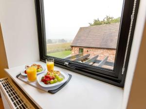 a tray of fruit and juice on a window sill at 3 Bed in Alcester 88396 in Coughton +11 photos