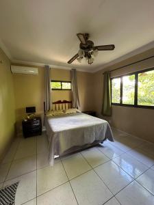 a bedroom with a bed and a ceiling fan at Complexo Barrigudos in Pacajus