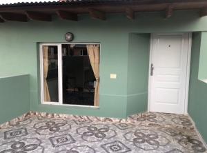 une pièce avec un mur vert et un miroir dans l'établissement Departamento Patagonia Alegre, à Puerto Madryn