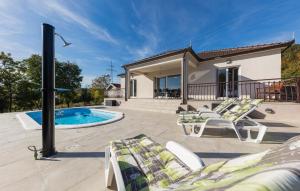 a patio with chairs and a swimming pool at Lovely Home In Sinj in Rožani +15 photos