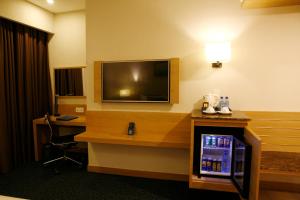 a hotel room with a television and a desk at Ciao SaiGon Hotel & Spa in Ho Chi Minh City