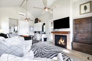a living room with a couch and a fireplace at Blanco - A Birdy Vacation Rental in Fredericksburg