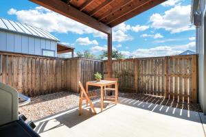 a patio with a table and a wooden fence at Blanco - A Birdy Vacation Rental in Fredericksburg