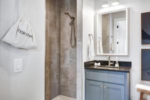 a bathroom with a shower and a sink and a mirror at Brazos - A Birdy Vacation Rental in Fredericksburg +30 photos