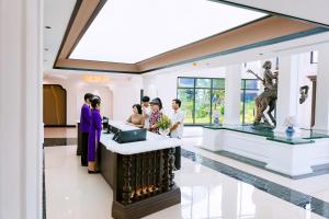 a group of people standing around a bar in a building at Soc Village Wellness & Retreat in Sóc Sơn +45 photos