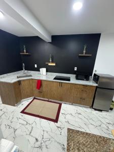 a kitchen with a sink and a counter top at Apartment near by NYC, EWR and Met Life in East Orange