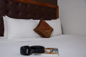 Postel nebo postele na pokoji v ubytování Samdi Da Nang Central Hotel