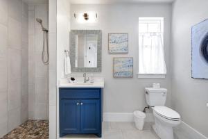 a bathroom with a toilet and a sink and a mirror at Frio - A Birdy Vacation Rental in Fredericksburg +26 photos