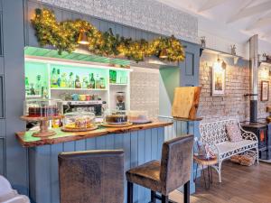 a restaurant with a counter and chairs in a room at 4 Bed in Hawick 95765 in Roberton