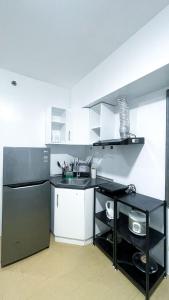 a kitchen with a sink and a refrigerator at Warm Urban Studio with modern design in Molo +2 photos