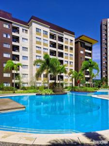 a large swimming pool in front of a building at Warm Urban Studio with modern design in Molo