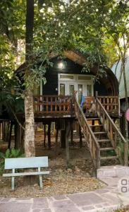 a house with a porch and a bench in front of it at Cat Tien Nature Hotel in Cat Tien
