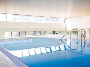 a large swimming pool in a building at Novotel Nürnberg Centre Ville in Nuremberg