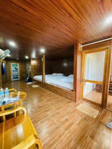 a bedroom with a bed and a table in a room at Cat Tien Nature Hotel in Cat Tien