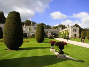 a garden with trees and a building in the background at 3 Bed in Lostwithiel 93041 in Lostwithiel