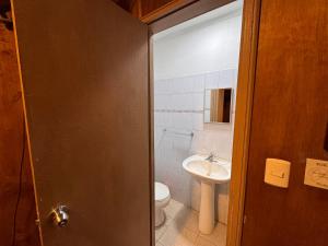 a bathroom with a toilet and a sink at Hotel de la Costa in Talcahuano