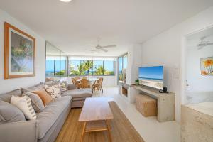 a living room with a couch and a tv at Ocean Vista Apartment, Sunrise Beach in Sunrise Beach