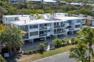 an aerial view of a white apartment building with palm trees at Ocean Vista Apartment, Sunrise Beach in Sunrise Beach