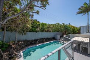 a swimming pool in a yard next to a fence at Ocean Vista Apartment, Sunrise Beach in Sunrise Beach