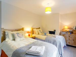 a bedroom with two beds and a dresser at 2 Bed in Alford 77637 in Rigsby
