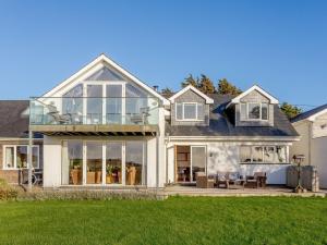 a house with large glass doors and a yard at 4 Bed in Wembury 54383 in Wembury